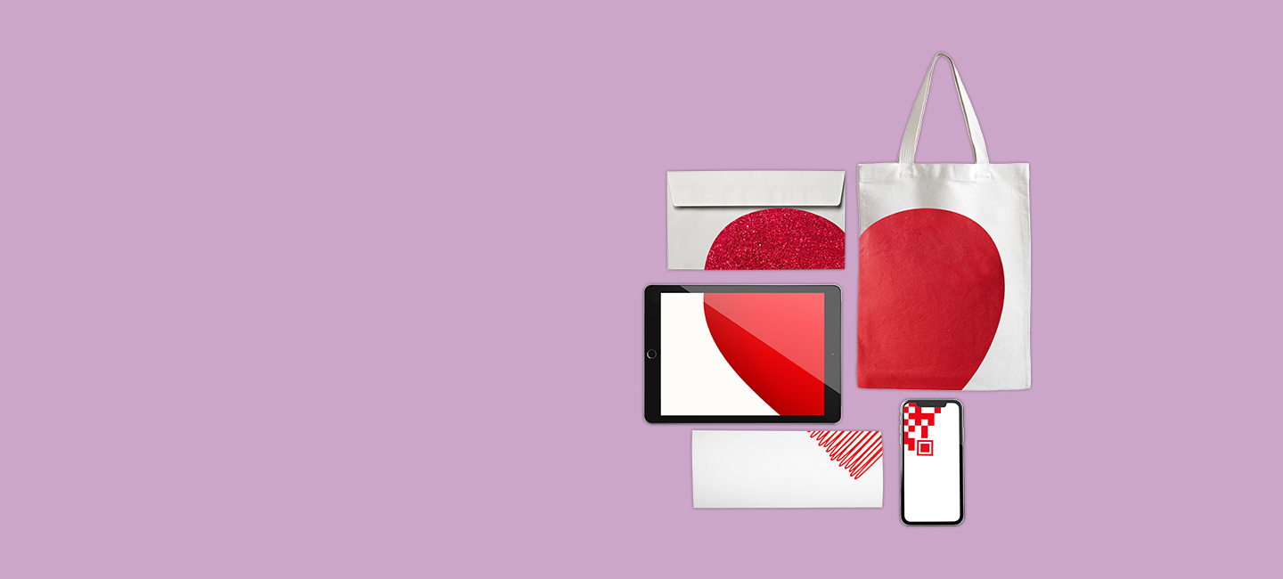 Acessórios e tablet que juntos formam um coração vermelho